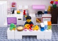 Lego man cooking dessert in domestic kitchen