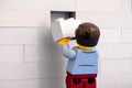 Lego man minifigure with gray brick finishing wall Royalty Free Stock Photo