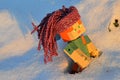 LEGO Minecraft action figure of Alex with dreadlock looking knitted handmade purple hat stuck in real deep snow.