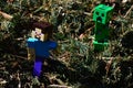 LEGO Minecraft action figure of Steve chased by green dangerous explosive mob called Creeper on pile of crushed fir-needles