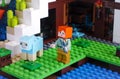 Lego Minecraft. Alex with sheep shears catching to shear the dyed sheep on Waterfall Base