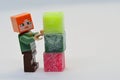 LEGO Minecraft figure of Alex is building colorful column from stearine scented wax cubes Royalty Free Stock Photo