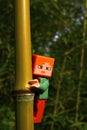 LEGO Minecraft figure of Alex embracing nodal part of bamboo plant from Phyllostachys genus.