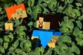 LEGO Minecraft large action figures of Steve and Alex walking through dense foliage of decorative succulent plant