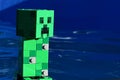 LEGO Minecraft large figure of explosive green Creeper mob swimming in blue pool water
