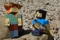 LEGO Minecraft large figures of Steve and Alex on shoreline rock, Alex standing with crab cephalothorax on her head