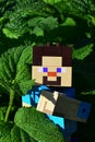 LEGO Minecraft smiling figure of Steve embracing green leaf of Lemon Balm, latin name Melissa Officinalis.