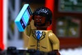 Lego mini-figure Guy making a phone call
