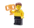 Lego minifigure in brand uniform hods a golden cup Royalty Free Stock Photo