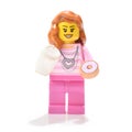 Lego minifigure girl in pink clothes with donut Royalty Free Stock Photo