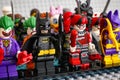 Lego minifigures standing in rows. In first row - Batman, The Joker, Harley Quinn, Batgirl