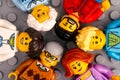 Lego minifigures - three generations of a family on gray baseplate background