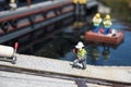 Lego model of construction worker phone near canal Royalty Free Stock Photo