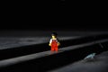 Lego movie hero standing on a black surface with dark, blurred background