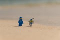 Lego movie minifigure spaceman Benny with robot on the baech Royalty Free Stock Photo