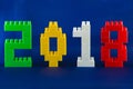 Lego New year 2018 concept with Lego cubes on blue background.