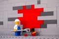 Lego painter minifigure painting a wall red