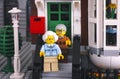 Lego senior couple standing on the porch of their house