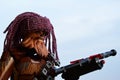 LEGO Star Wars action figure of Wookie Chewbacca with crossbow and handmade knitted purple winter cap looking like dreadlocks. Royalty Free Stock Photo