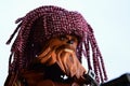 LEGO Star Wars action figure of Wookie Chewbacca with handmade knitted purple winter cap looking like dreadlocks. Royalty Free Stock Photo