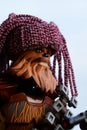 LEGO Star Wars action figure of Wookie Chewbacca with his crossbow and handmade knitted purple winter cap looking like dreadlocks. Royalty Free Stock Photo