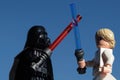 Lego Star Wars figures of Luke Skywalker and Darth Vader fighting with lightsabers Royalty Free Stock Photo