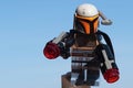Lego Star Wars Mandalorian warrior with grey and orange armor, holding two large guns. Royalty Free Stock Photo