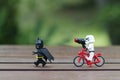 lego storm trooper riding bicycle chasing lego batman.