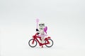 Lego storm trooper wearing fairy costume riding bicycle.