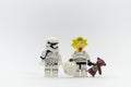 Lego storm troopers with maggie head holding teddy bear.