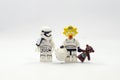 Lego storm troopers with maggie head holding teddy bear.