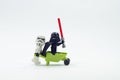 lego stormtrooper pushing wheelbarrow with darth vader sitting on it Royalty Free Stock Photo