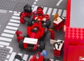 Lego team crew members fixing wheel of Ferrari F14 T race car