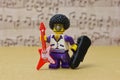 Lego Toy male figure smiling character with an afro, goatee Wearing funky glasses, with guitar Royalty Free Stock Photo