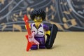 Lego Toy male figure smiling character with an afro, goatee Wearing funky glasses, with guitar