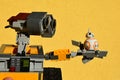 LEGO Wall-E robot from Disney Pixar movie holding small model of Star Wars spherical droid BB8 on his left arm