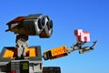 LEGO Wall-E robot from Disney Pixar movie holding small pink LEGO Minecraft pig mob on his left arm