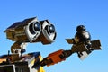 LEGO Wall-E robot model from Disney Pixar movie holding small model of Star Wars BB9E imperial droid on his left manipulator arm