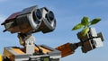 LEGO Wall-E robot from the movie of the same name by Disney Pixar studios, examining young sprout of basil plant