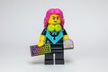 Lego woman with pink hair holding a colorful keyboard