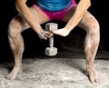 Legs and arms of woman squat weight with white powder