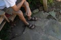 Legs and arms of a young man against a stone background, creative copy space Royalty Free Stock Photo