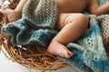 Legs of baby lying on wicker cradle close-up Royalty Free Stock Photo