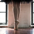 Legs of a ballerina closeup. The legs of a ballerina in old pointe. Rehearsal ballerina in the hall. Contour light from the window Royalty Free Stock Photo