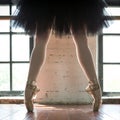 Legs of a ballerina closeup. The legs of a ballerina in old pointe. Rehearsal ballerina in the hall. Contour light from the window Royalty Free Stock Photo