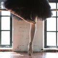 Legs of a ballerina closeup. The legs of a ballerina in old pointe. Rehearsal ballerina in the hall. Contour light from the window Royalty Free Stock Photo