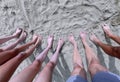 long legs with bare feet of a large family of 5 on the sand