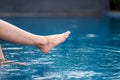 Legs and barefoot kicking and soaking water in the pool Royalty Free Stock Photo