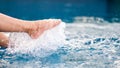 Legs and barefoot kicking and splashing water in the pool Royalty Free Stock Photo