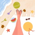 Legs of beautiful girl on sand beach, view from above, feet in flip flops on towel Royalty Free Stock Photo